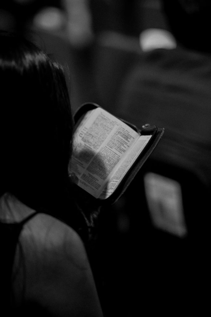 woman reading a bible in a religious setting