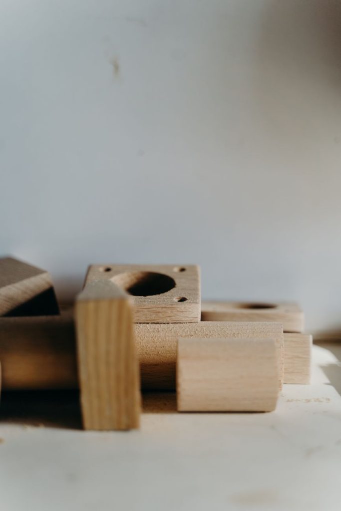 close up of wooden items lying on a white surface
