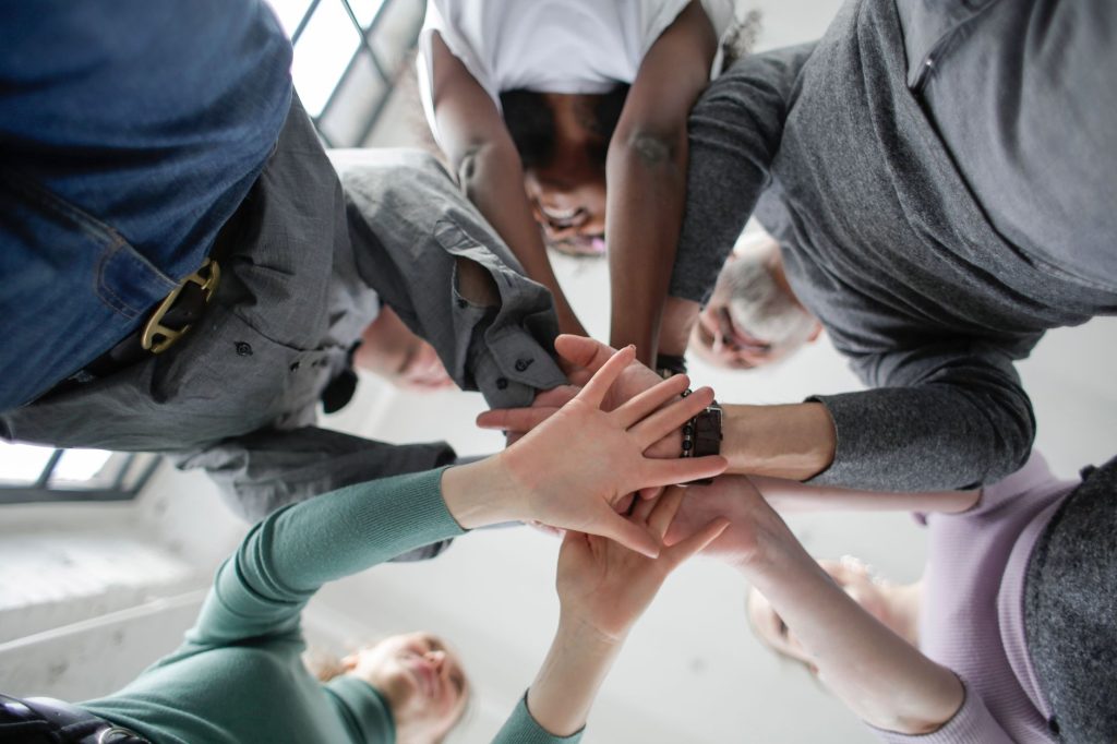 low angle photo of people holding hands together